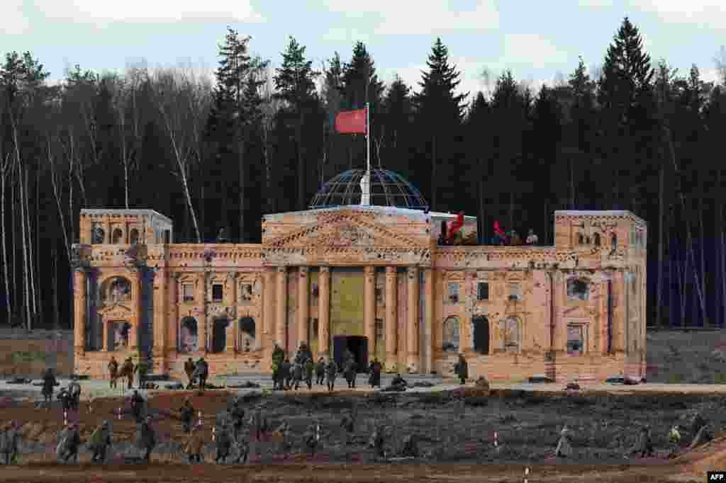 Participants storm a replica of the Reichstag during a historical military reenactment of The Battle of Berlin to mark the 72nd anniversary of the crucial World War II engagement in the German capital. (AFP/Vasily Maximov)