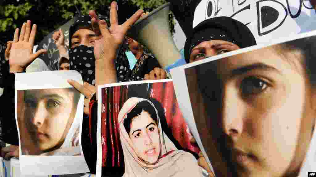 Islamist activists in Lahore&nbsp;carry photographs of Malala during a protest against the assassination attempt.
