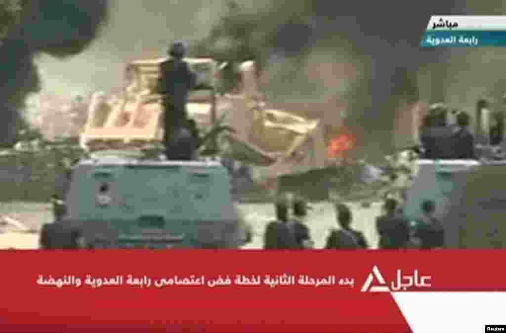 A still from television footage shows a bulldozer demolishing a barricade set up by protesters.