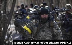 Ukrainian soldiers move during an operation to take back a settlement in the Kyiv region from Russian forces on March 10.