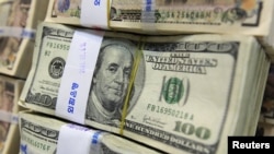 South Korea -- Stacks of US 100 dollar notes are pictured at the headquarters of the Exchange Bank in Seoul, 02Aug2011