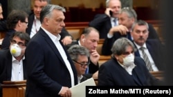 Виктор Орбан (стоит) среди депутатов парламента, во время заседания 30 марта 2020