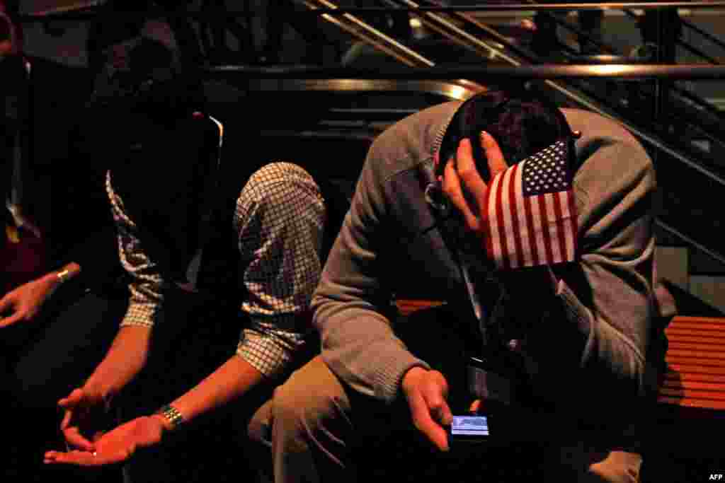 A spectator waits for Republican presidential candidate Mitt Romney, to make his concession speech in Boston.