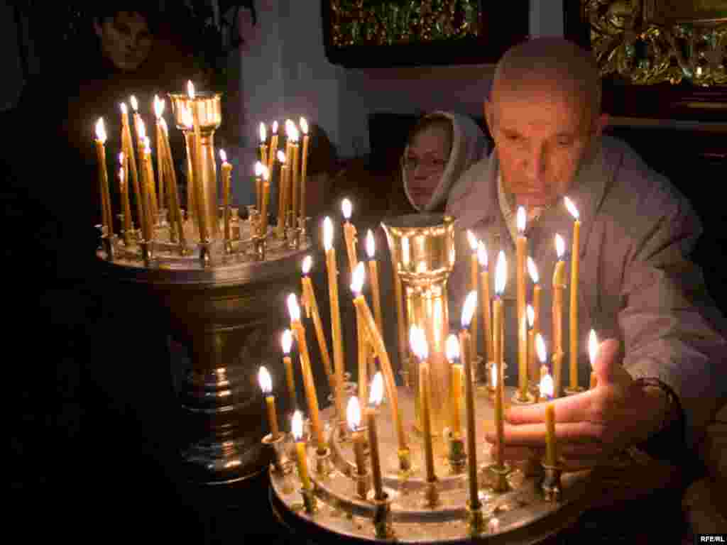 Believers light candles at the St. Peter Cathedral in Minsk, Belarus.