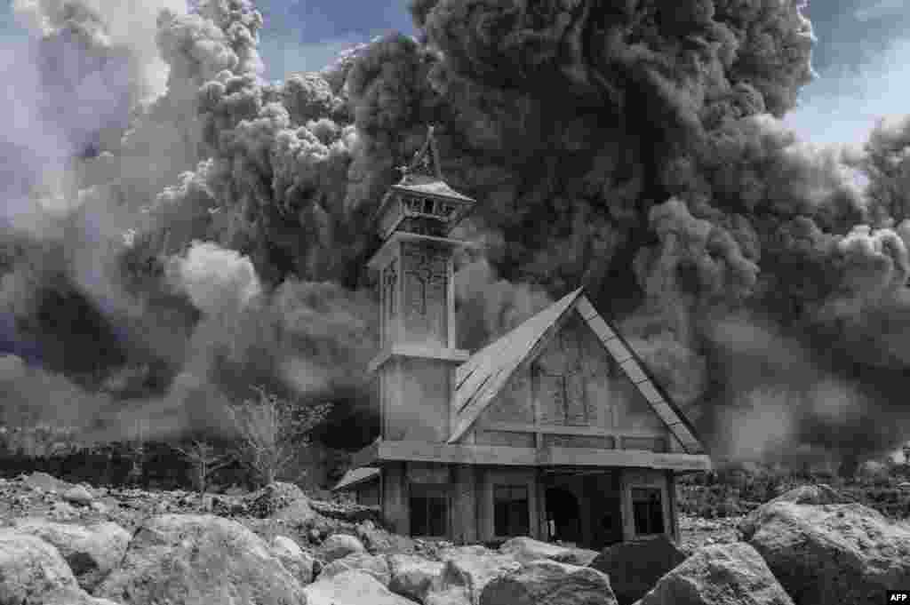 Ash from the Mt. Sinabung volcano fills the sky over an abandoned church during another eruption in Karo, in Indonesia's North Sumatra Province. (AFP/Sutanta Aditya)