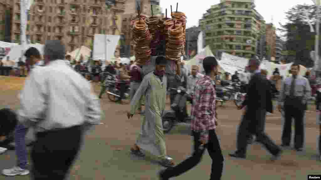 A street vendor selling bread walks among antigovernment protesters on Cairo&#39;s Tahrir Square. (Reuters/Asmaa Waguih)