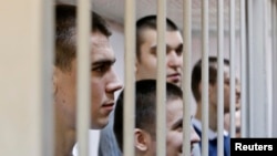 Defendants in the Bolotnaya case wait for their sentencing in a holding cell during a court hearing in Moscow on February 24.