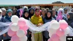 Pakistani Nobel Peace Prize laureate Malala Yousafzai (center) poses with Syrian refugees on her 18th birthday during the opening of the Malala Yousafzai All-Girls School built by the Kayany Foundation in Barr Elias, Lebanon, on July 12.
