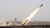 Members of Iraq's Shi'ite paramilitaries launch a rocket towards Islamic State militants on the outskirts of the city of Falluja, in the province of Anbar on July 12. 