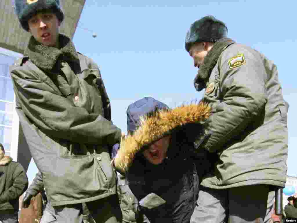 Police detain an opposition supporter in Irkutsk.