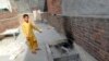 A local resident shows the place where Zeenat Rafiq was allegedly burnt alive by her mother in the eastern Pakistani city of Lahore on June 8.