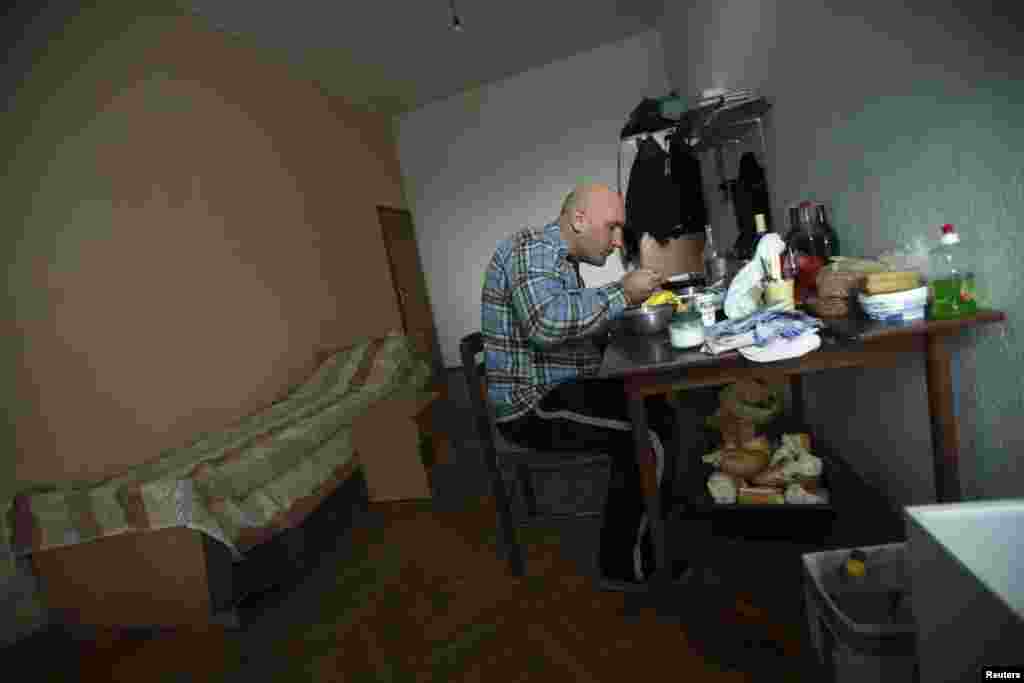 Matovic eats a meal in his makeshift home.