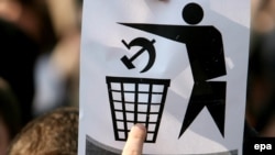 A student shows an anticommunist sign during protests in Chisinau