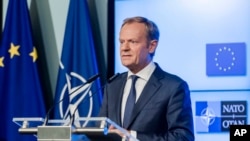 FILE - In this July 10, 2018, file photo, European Council President Donald Tusk addresses the media after the signature of the second EU NATO Joint Declaration, in Brussels. The senior European Union official on Monday, July 16, 2018, urged President Do