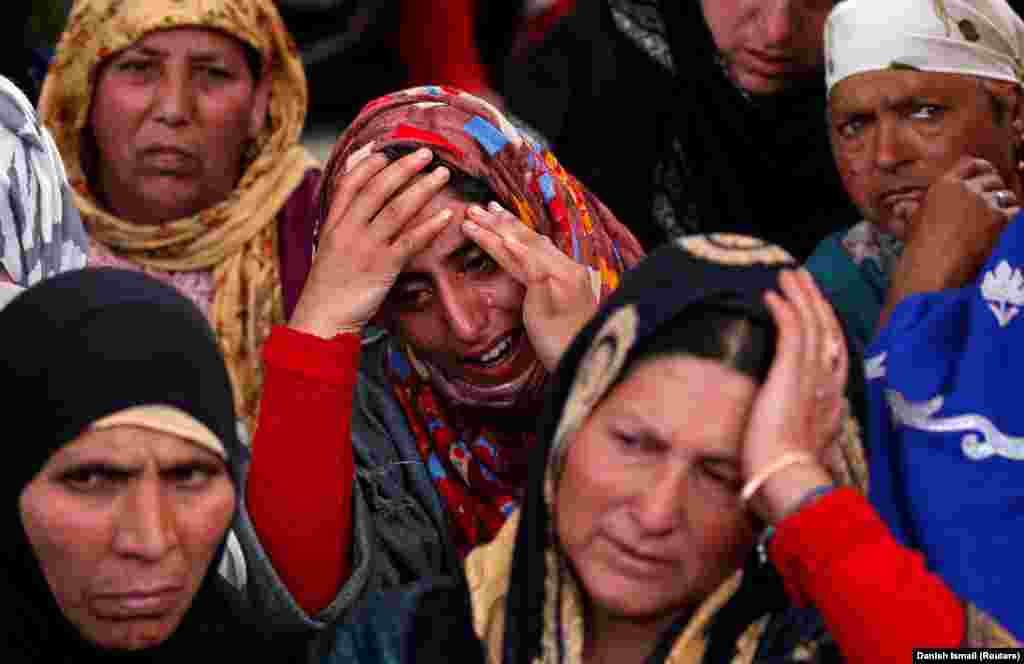 Women mourn near the body of Sharjeel Ahmed Sheikh, a civilian who local media say died during clashes between protesters and Indian security forces, during his funeral in the village of Khudwani in South Kashmir&#39;s Kulgam district. (Reuters/Danish Ismail)
