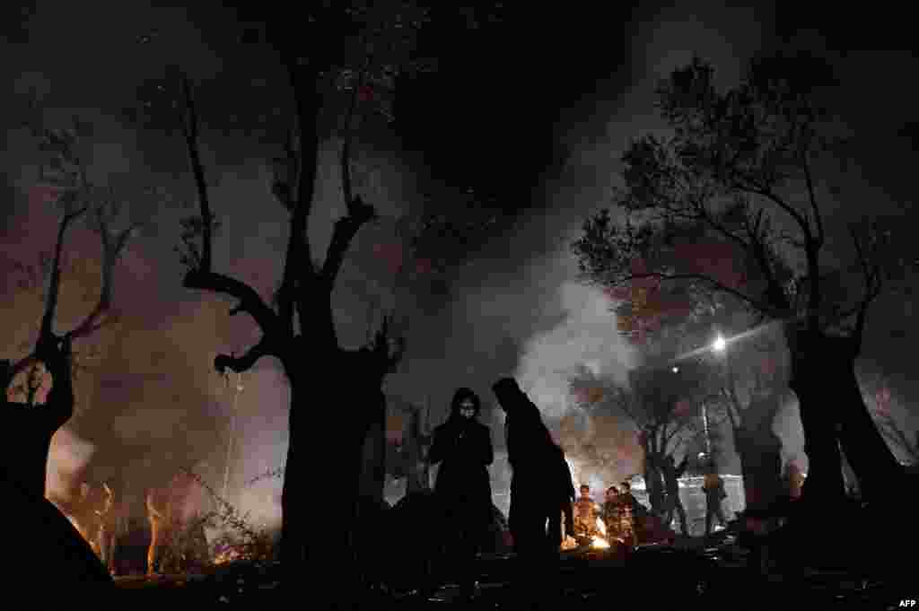 Refugees and migrants spend the night in a field on the Greek island of Lesbos. (AFP/Aris Messinis)