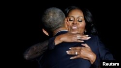 U.S. - U.S. President Barack Obama embraces his wife Michelle Obama after his farewell address in Chicago, Illinois, U.S. January 10, 2017