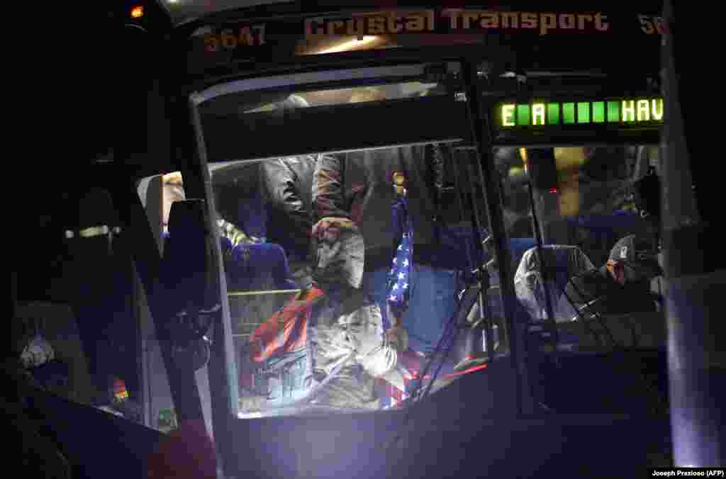 U.S. -- Supporters of US President Donald Trump board a bus for an overnight drive to Washington, DC, in Newton, Massachusetts on January 5, 2021.