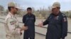 PAKISTAN -- In this photo taken on October 16, 2018, a Pakistani border security official (R) and an Iranian border official meet at Zero Point in the Pakistan-Iran border town of Taftan. 