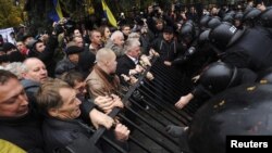 Riot police block demonstrators demolishing a fence during a protest rally in front of the parliament headquarters in Kiyv earlier this month.