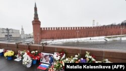 Архивска фотографија - Поддржувачи на Немцов редовно оставаат цвеќе и негови фотографии на местото кад беше застрелан