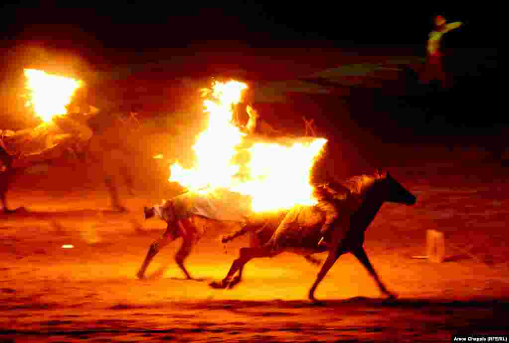 Flaming horsemen gallop through the opening ceremony. The games are devoted to traditional sports of Central Asia.