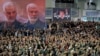 Supporters of the Iranian regime chant slogans during Friday Prayers in the capital Tehran, while a poster (R) proclaims "Death to America". January 17, 2020