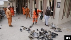 Workers clean the scene of a suicide bomb attack that targeted a Shi'ite mosque in Kabul on November 21.