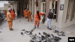 Workers clean the scene of a suicide bomb attack that targeted a Shi'ite mosque in Kabul on November 21 that killed at least 30 people. 