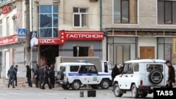 Police examine the site of a blast outside a grocery store in Makhachkala, Daghestan, on November 8.