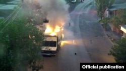 Armenia - A police vehicle which the Armenia police say was set on fire by opposition gunmen, 25Jul2016.