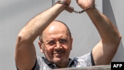 Oyub Titiyev gestures as he leaves a court building in Grozny on July 3.