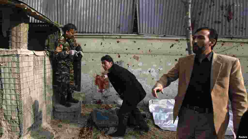 Afghan investigators inspect the scene.