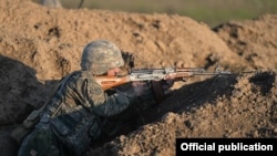 Nagorno-Karabakh - An Armenian soldier shoots during a military exercise, 20Nov2015.