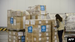 Ethiopia - A staff member checks boxes of mostly personal protective equipment (PPE) for the World Health Organization (WHO) at Ethiopia Airlines' cargo facility at the Bole International Airport in Addis Ababa, Ethiopia, on April 14, 2020.