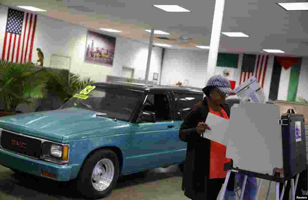 A voter looks over her ballot at Sam&#39;s Auto Sales in Chicago, Illinois.