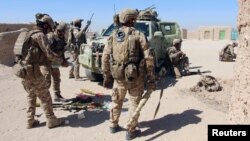 Afghan special forces prepare themselves for battle with the Taliban on the outskirts of Lashkar Gah in Helmand Province on October 10.