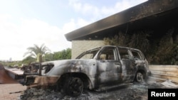 A burned car is seen in front of the U.S. Consulate in Benghazi, Libya, after it was attacked and set on fire by gunmen on September 11, 2012.