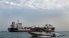 A boat of Iranian Revolutionary Guard sails next to Stena Impero, July 21, 2019