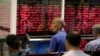 IRAN -- Iranian men monitor the stock market at Tehran Stock Exchange on July 1, 2019.