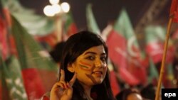 A supporter of anti-government opposition listens to a speech on the seventh day of a mass anti-government protest in Islamabad, August 21, 2014.
