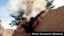 FILE: A U.S. Marine dodging insurgents bullets in Helmand (May 2008).