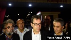 Kadri Gursel (center) speaks to the media after his release from prison in Istanbul on September 26.