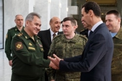 Министр обороны России Сергей Шойгу встречается с Башаром Асадом во время очередного визита в Дамаск. 23 марта 2020 года