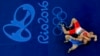 Алмат Кебіспаев (көк формада) Рио олимпиадасында ирандық балуанмен күресіп жатқан сәт. 14 тамыз 2016 жыл.