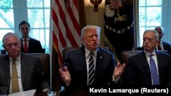 Flanked by Secretary of State Rex Tillerson and Defense Secretary James Mattis, U.S. President Donald Trump meets with members of his cabinet at the White House in Washington, U.S., October 16, 2017.