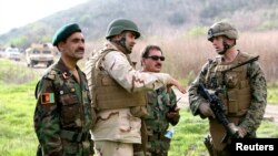 Afghan national army officers discuss lessons learned alongside Marines and Navy personnel while participating in combat scenario training exercises at U.S. Marine Corps Base Camp Pendleton in California in 2010.