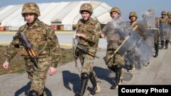 Kosovo - Armenian soldiers walk in riot gear to a UH-60 Black Hawk during a training exercise on Camp Bondsteel, Kosovo, March 12, 2014. (Photo courtesy of www.army.mil)