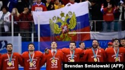 The Olympic Athletes from Russia players sing the Russian national anthem after receiving their gold medals on the podium during the medal ceremony after the men's gold-medal ice-hockey match against Germany on February 25.