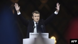 France -- French president-elect Emmanuel Macron greets supporters as he arrives to deliver a speech in front of the Pyramid at the Louvre Museum in Paris on May 7, 2017, after the second round of the French presidential election.